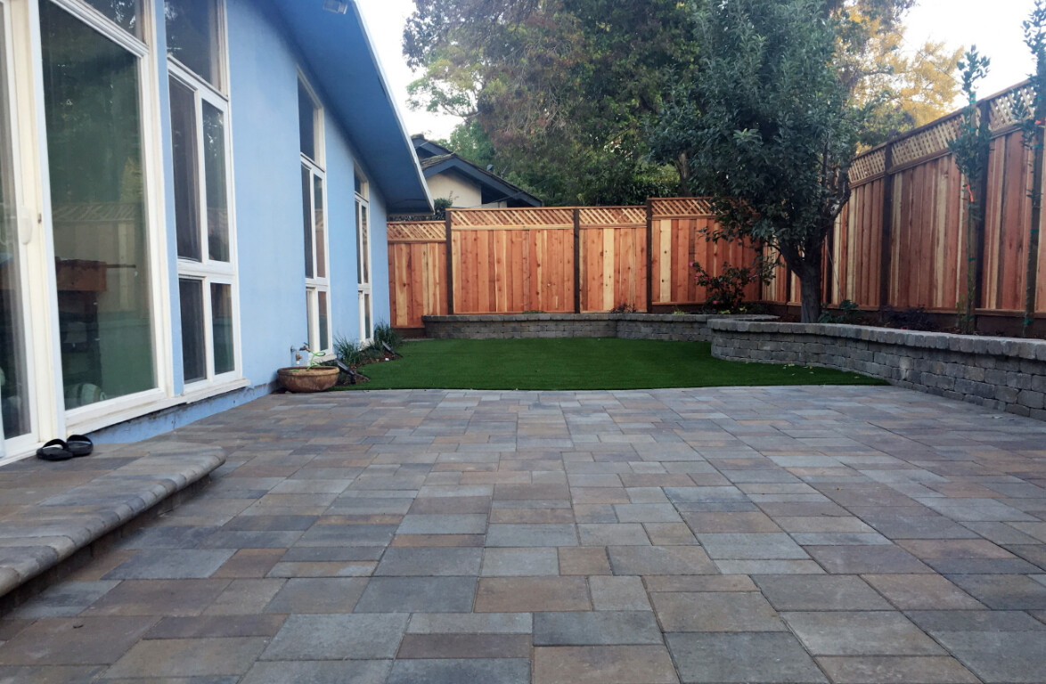 Finished decorative stamped concrete patio with retaining wall in Carson, CA